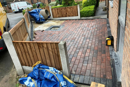 block paving in red with a black boarder with new fencing