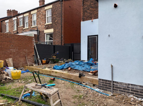 railway sleepers being used as artificial lawn frame