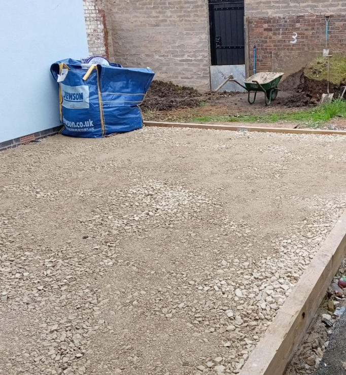 artificial lawn base using hardcore and a railway sleeper frame