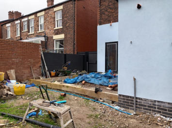 railway sleepers being used as artificial lawn frame